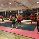 Adults training in a kickboxing class